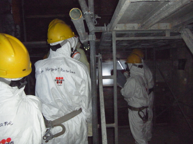 NRC Chairman Allison Macfarlane and other NRC officials in the darkened interior of Reactor 4 at the Fukushima Dai-ichi nuclear complex northeast of Tokyo Dec. 13.