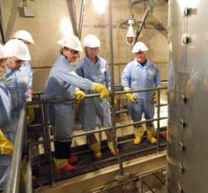 NRC Chairman Allison Macfarlane (second from right) listens as Southern California Edison executive Richard St. Onge (third from right) discusses issues with one of the damaged steam generators at SONGS. The steam generator is in the right foreground. 